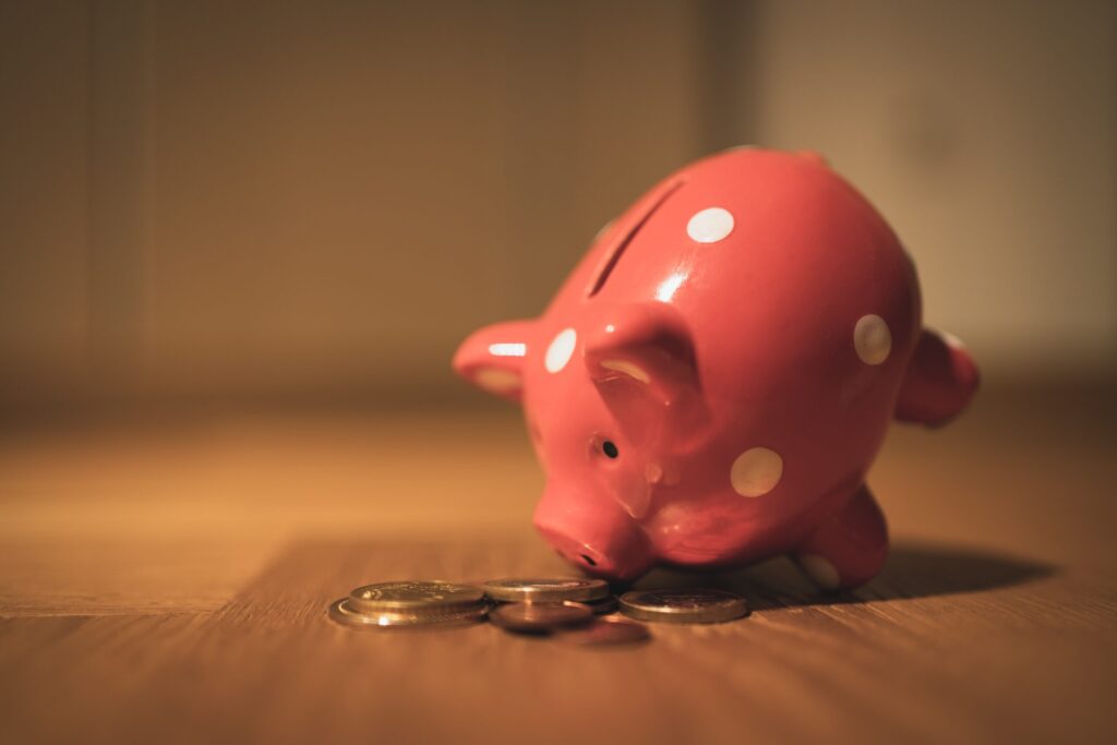 close up of a piggy bank with coins