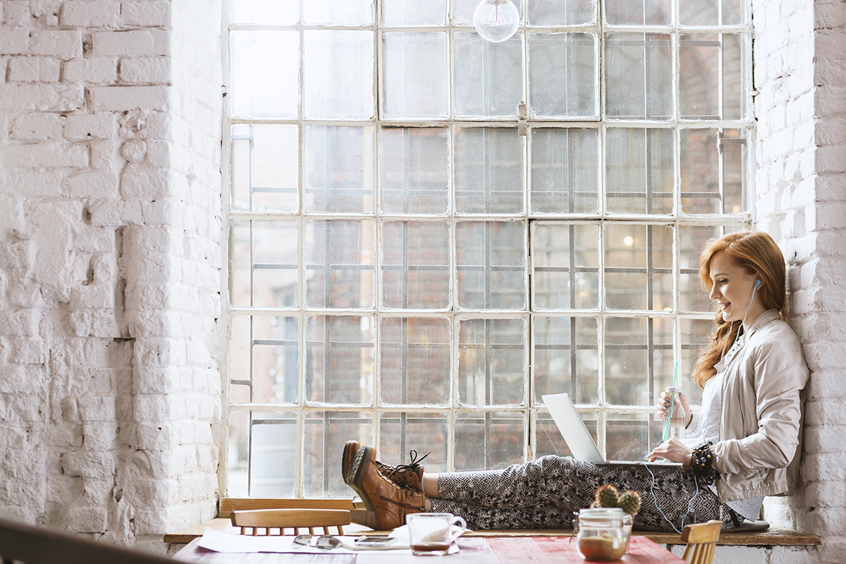 woman sitting on window sill
